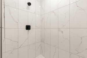 Bathroom featuring a tile shower