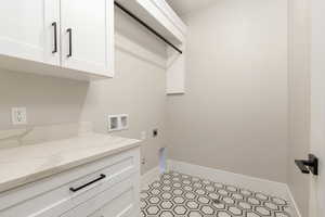 Laundry area featuring washer hookup, hookup for an electric dryer, and cabinet space