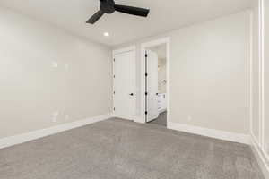 Unfurnished bedroom featuring carpet floors, a ceiling fan, recessed lighting, and ensuite bathroom