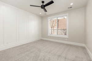Spare room featuring light colored carpet, recessed lighting, and a ceiling fan