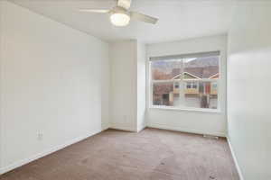 Empty room featuring carpet flooring and baseboards