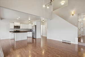 Unfurnished living room featuring dark wood finished floors and recessed lighting