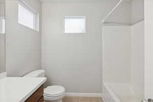 Full bathroom featuring vanity, light tile patterned flooring, bathtub / shower combination, and plenty of natural light