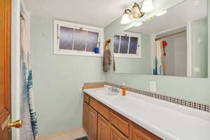 3/4 Bathroom featuring vanity and a shower with curtain