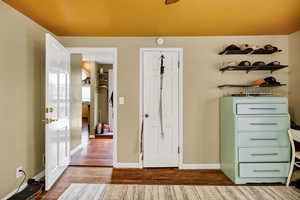 3rd Bedroom with a ceiling fan, multiple windows, a desk, and dark wood-style flooring