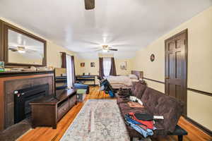 1 st Bedroom featuring a glass covered fireplace and light wood-style floors