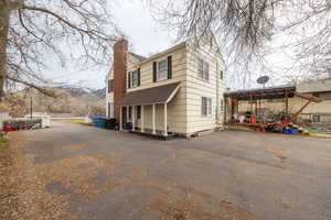 View of side of home with a chimney and a mountain view
