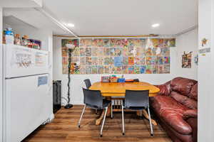 Dining area with wood finished floors and recessed lighting