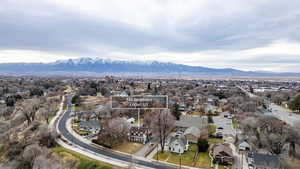 Aerial perspective of suburban area with a mountain backdrop and property boundaries highlighted