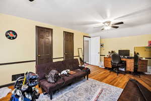1 st Bedroom featuring a glass covered fireplace and light wood-style floors