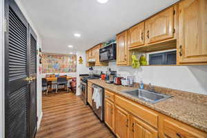 Kitchen featuring appliances with stainless steel finishes, dark wood-style flooring, and recessed lighting