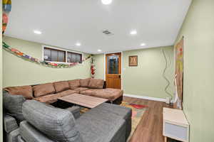 Living area featuring wood finished floors and recessed lighting