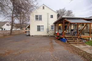 Rear view of house with driveway and a wooden deck