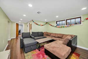 Living area featuring recessed lighting and dark wood finished floors