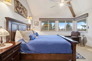 Carpeted bedroom with ceiling fan and baseboards