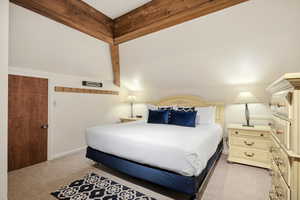 Bedroom with light colored carpet and baseboards