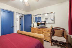 Bedroom with carpet floors, a ceiling fan, and a closet