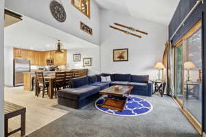 Living room featuring high vaulted ceiling