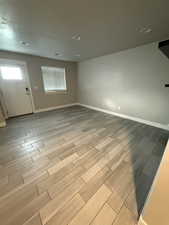 Empty room featuring wood finish floors and recessed lighting