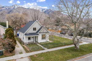 Bungalow featuring a porch, roof with shingles, and a mountain view