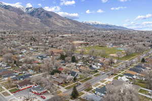 Aerial overview of property's location with a mountain backdrop and nearby suburban area