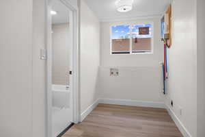 Laundry room with hookup for a washing machine, light wood-type flooring, and electric dryer hookup