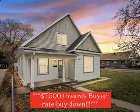 Bungalow featuring a porch, roof with shingles, and a front lawn