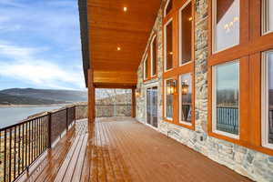 Deck with a water and mountain view
