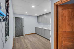 Bar with gray cabinets, light countertops, a paneled ceiling, light wood-style flooring, and recessed lighting