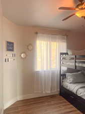 Bedroom with wood finished floors and a ceiling fan