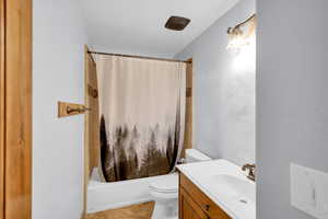 Bathroom with vanity, shower / tub combo with curtain, and light tile patterned flooring