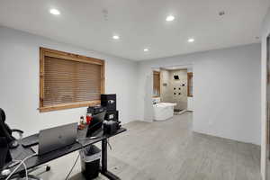Workout area featuring recessed lighting and light wood finished floors