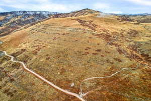 Aerial view of property and surrounding area featuring mountains
