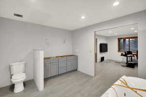 Full bathroom with recessed lighting, a tub with jets, and vanity