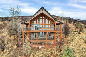 Back of property featuring stone siding