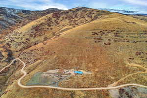 Aerial view of property and surrounding area featuring mountains