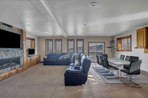 Living room with a large fireplace and beamed ceiling
