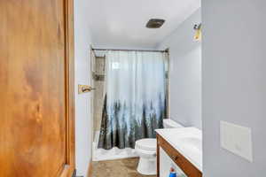 Full bathroom featuring shower / tub combo with curtain and vanity