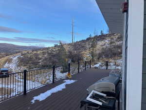 Snow covered deck with area for grilling