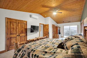 Carpeted bedroom featuring wooden ceiling, access to exterior, vaulted ceiling, and ceiling fan