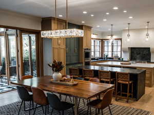 Dining area with light wood-style flooring, recessed lighting, and crown molding