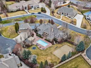 Aerial overview of property's location with nearby suburban area and a pool area