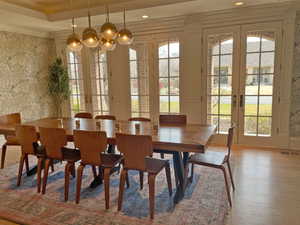 Dining area with french doors, wallpapered walls, crown molding, light wood-style flooring, and recessed lighting