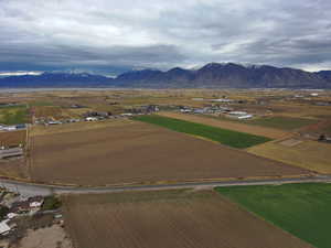 Overview of rural landscape with farmland and a mountain backdrop