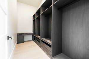 Walk in closet featuring light wood-style floors