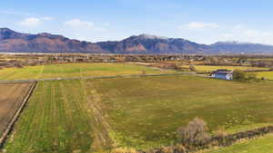 View of mountain background with rural landscape and rows of crops
