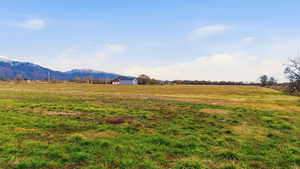 View of mountain backdrop featuring rural landscape