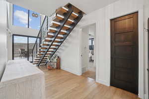 Stairway with wood-type flooring and plenty of natural light