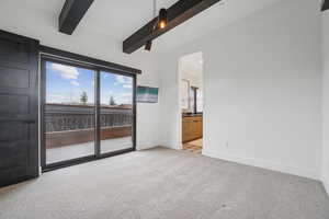 Unfurnished bedroom featuring light carpet and access to exterior