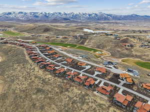 Aerial view of property's location with mountains and nearby suburban area